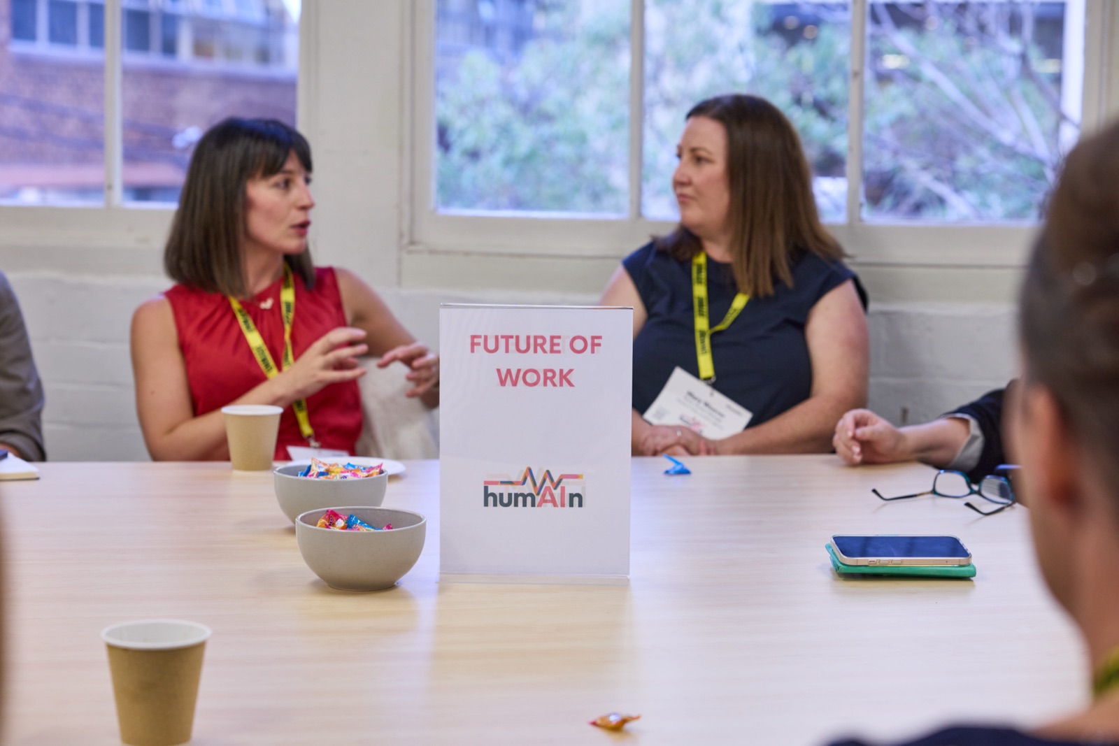 Two delegates in conversation at a Future of Work roundtable