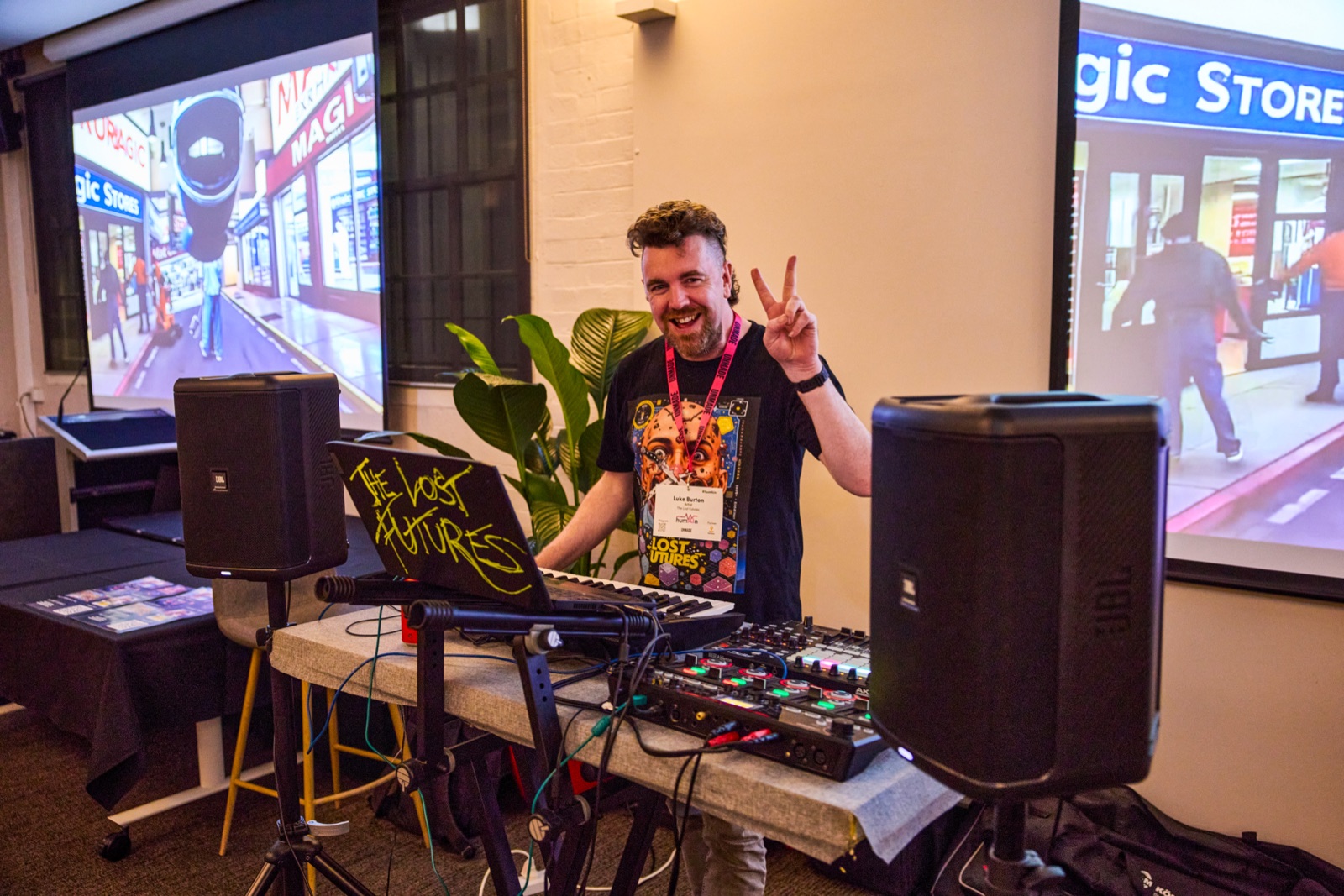 Luke Burton of The Lost Futures performing live at the event, giving a peace sign