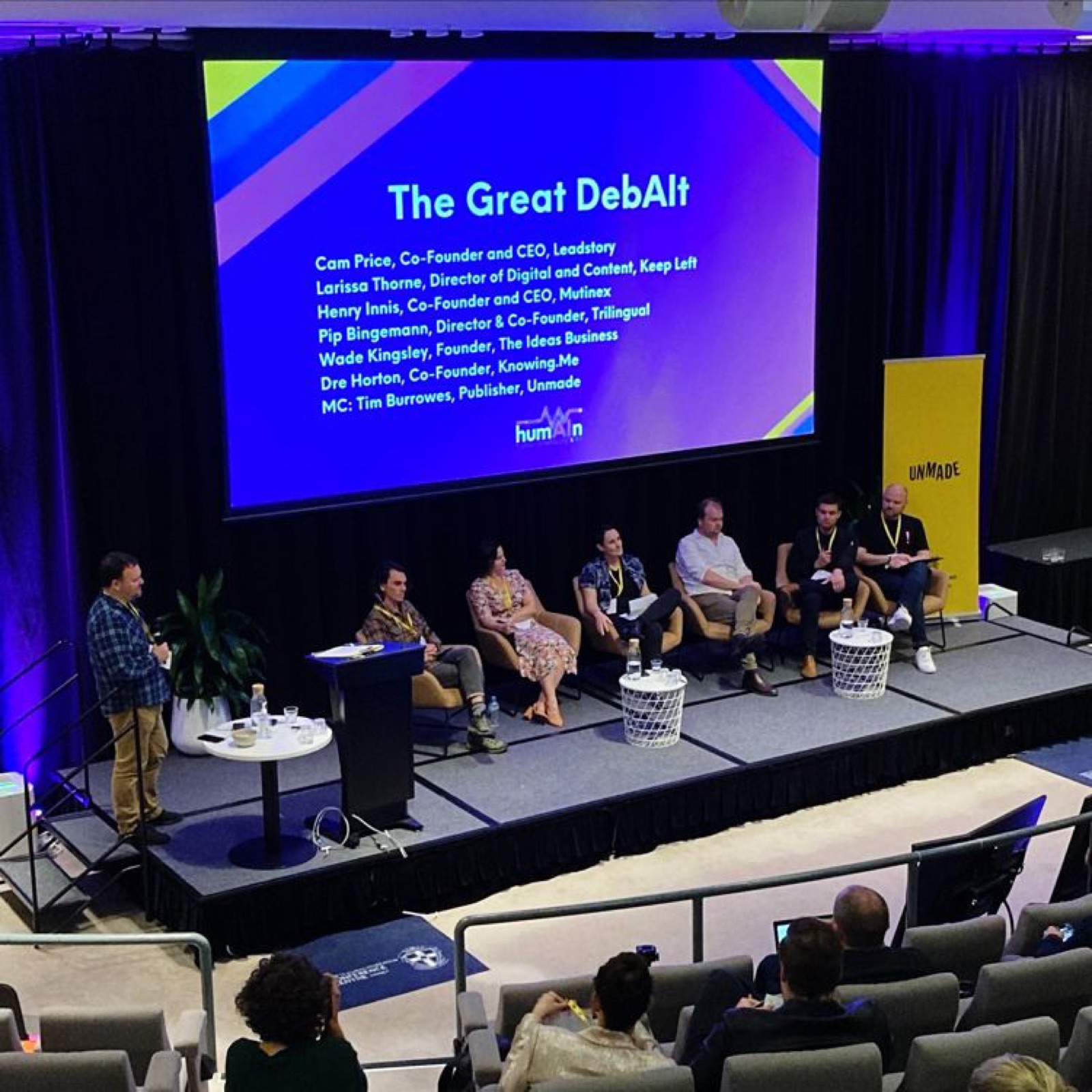 The Great DebAlt panel on stage with MC Tim Burrowes and six panellists