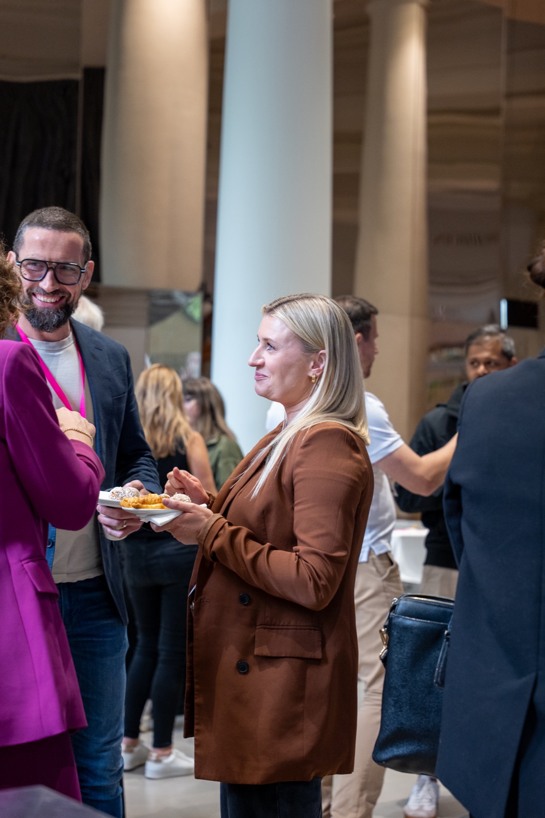 Two delegates chatting over food during a break