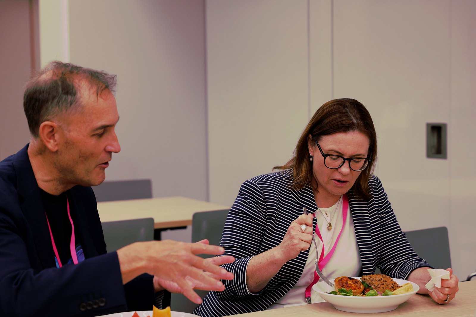 Two delegates talking over lunch